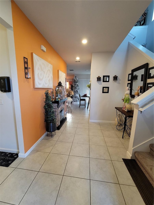 corridor featuring light tile patterned floors, stairway, recessed lighting, and baseboards