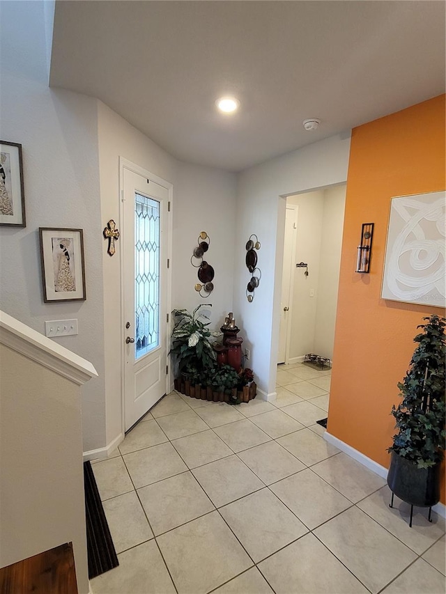 entryway featuring light tile patterned floors and baseboards