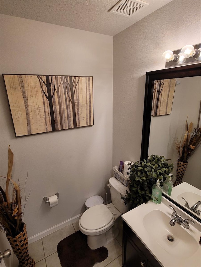 half bath with tile patterned flooring, visible vents, a textured ceiling, and toilet