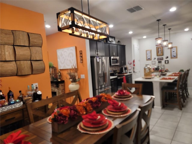 dining room featuring light tile patterned flooring, visible vents, and recessed lighting