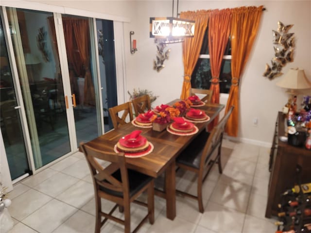 dining room with light tile patterned floors and baseboards