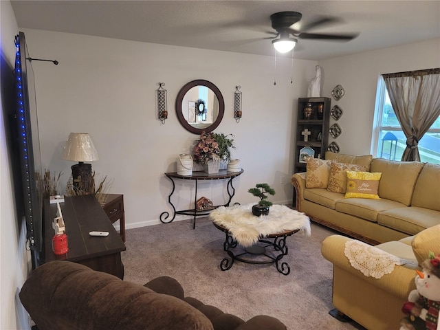 carpeted living room featuring a ceiling fan and baseboards