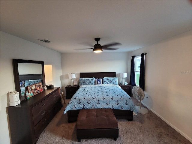 bedroom featuring a ceiling fan, visible vents, dark carpet, and baseboards