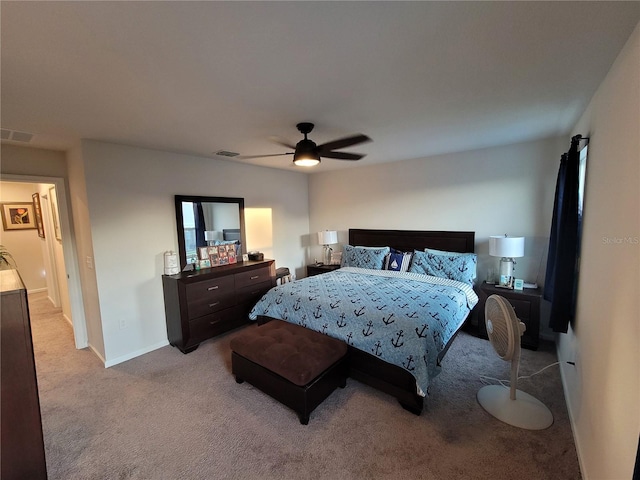 bedroom featuring baseboards, a ceiling fan, visible vents, and light carpet