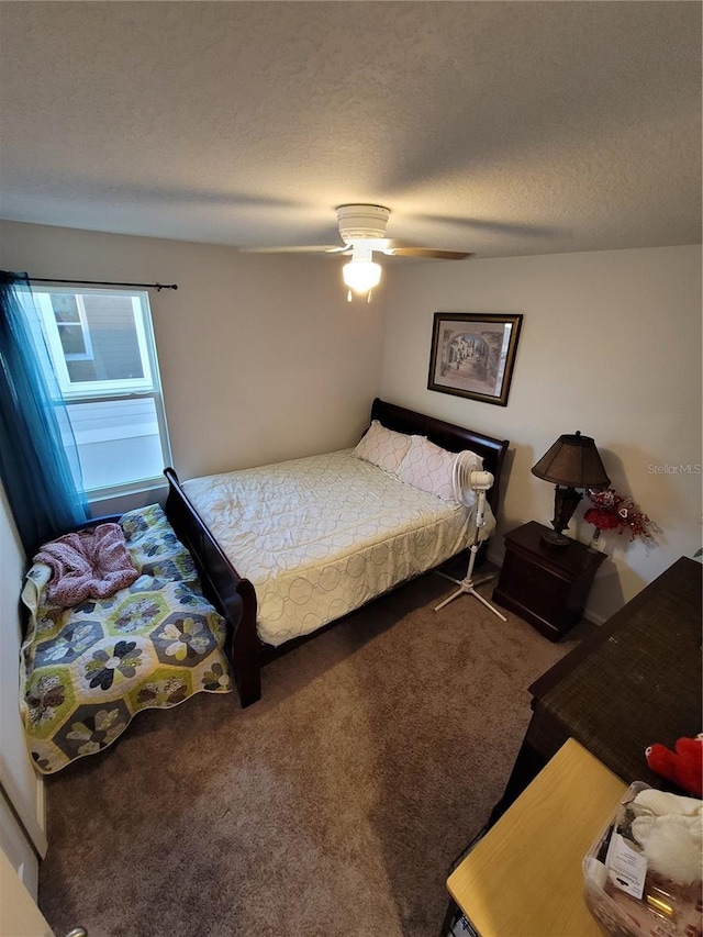 carpeted bedroom with ceiling fan and a textured ceiling