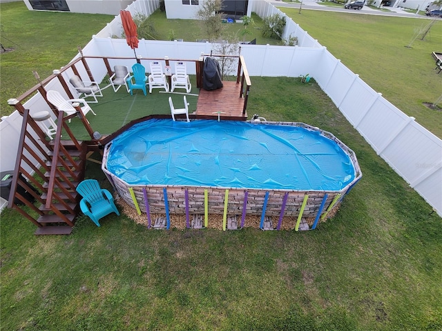 view of pool featuring a fenced in pool, a fenced backyard, and a lawn