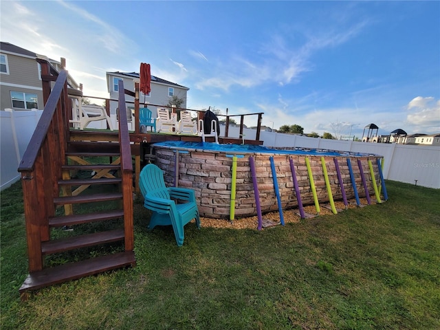 view of jungle gym featuring a fenced in pool, a lawn, and a fenced backyard