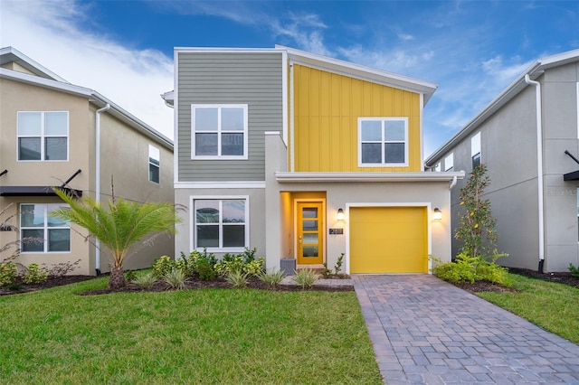 view of front of property featuring a front yard and a garage