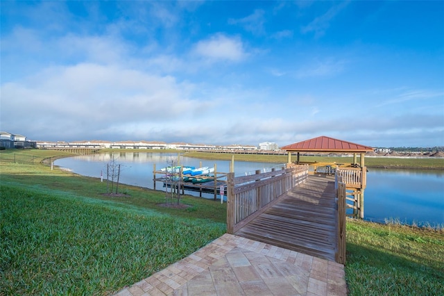 view of dock featuring a lawn, a water view, and a gazebo