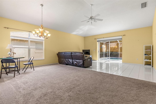 tiled living room with lofted ceiling, ceiling fan with notable chandelier, and a textured ceiling