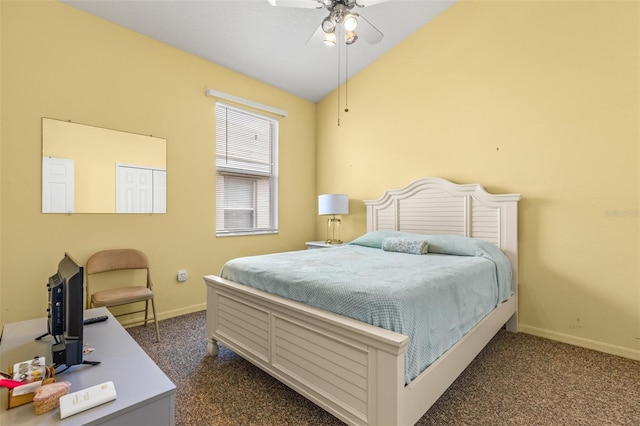 bedroom with lofted ceiling, ceiling fan, and dark carpet