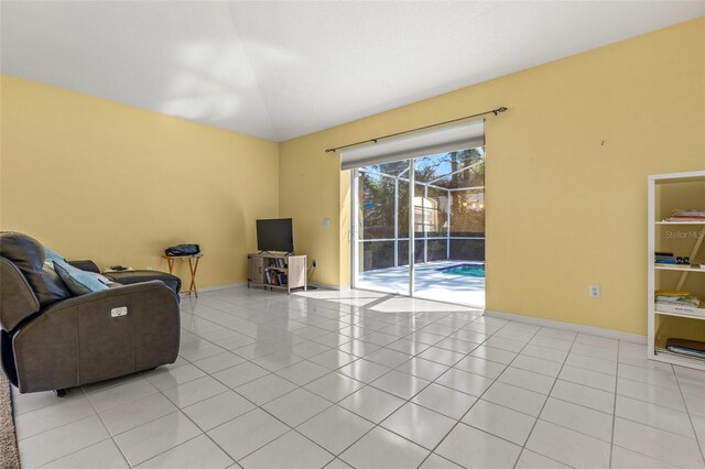 living room with lofted ceiling and light tile patterned floors