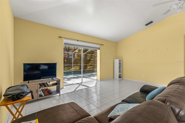 tiled living room with lofted ceiling and ceiling fan