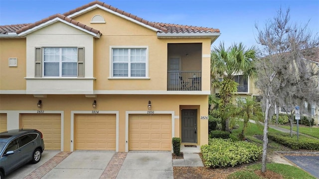 view of property featuring a balcony and a garage