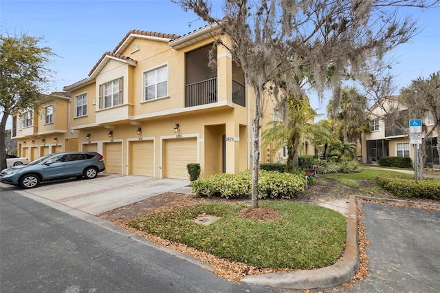 multi unit property with a balcony and a garage