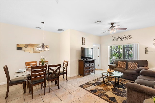 living room featuring ceiling fan with notable chandelier and light tile flooring