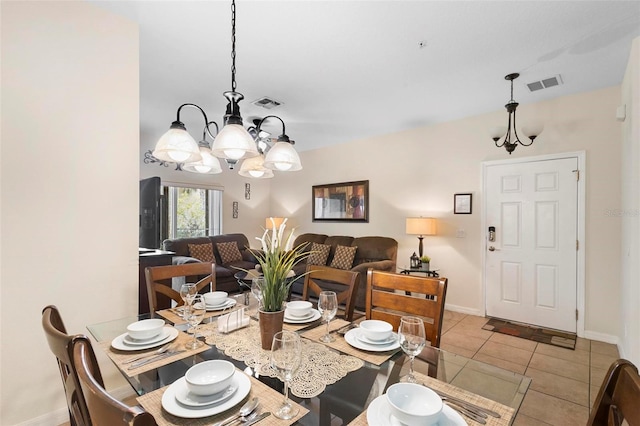 dining room with light tile floors and an inviting chandelier