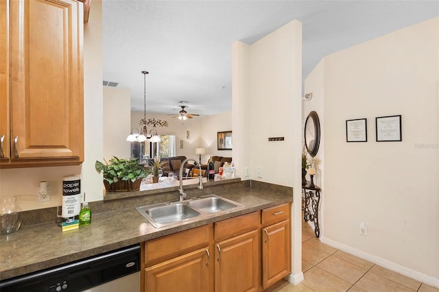 kitchen with ceiling fan with notable chandelier, sink, light tile floors, dishwasher, and pendant lighting