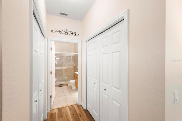 hallway featuring light tile floors