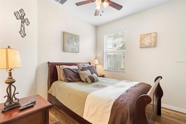 bedroom with ceiling fan and dark hardwood / wood-style floors