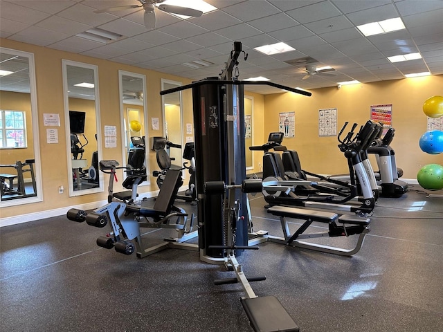 workout area with ceiling fan and a drop ceiling