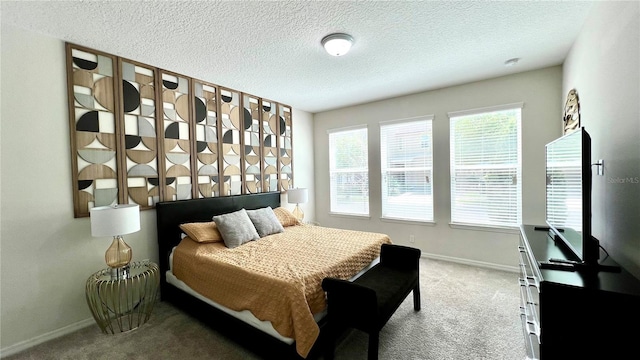 bedroom with a textured ceiling and carpet floors