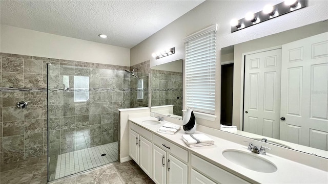 bathroom featuring tile flooring, oversized vanity, an enclosed shower, and double sink