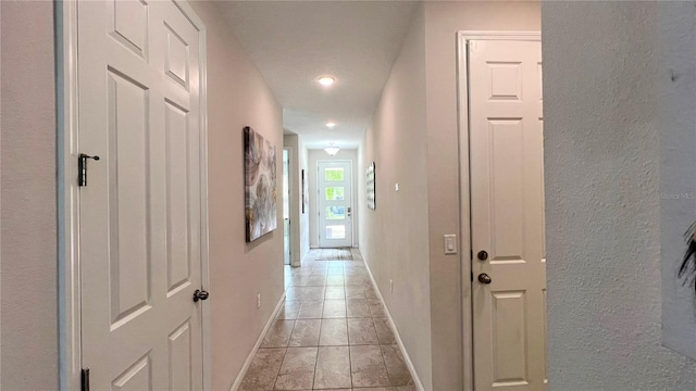 hallway featuring light tile floors