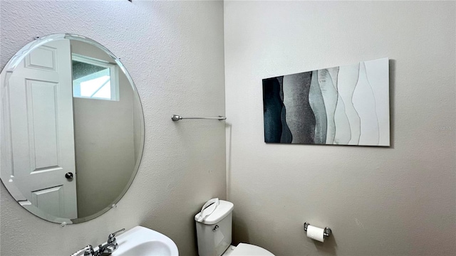 bathroom featuring sink and toilet