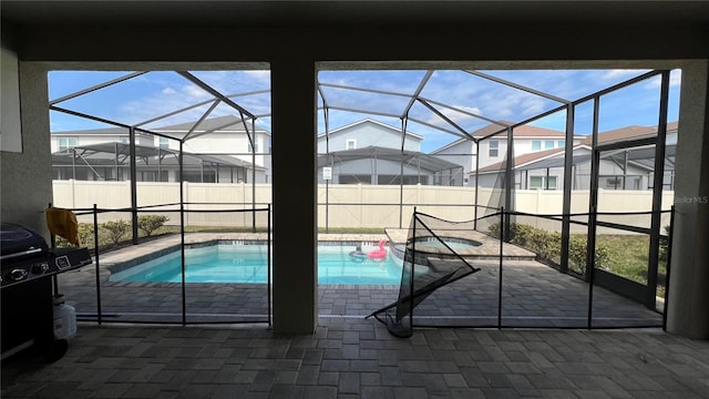 view of pool featuring a patio area and glass enclosure