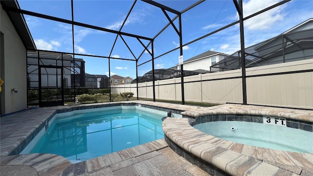 view of pool featuring an in ground hot tub and a lanai