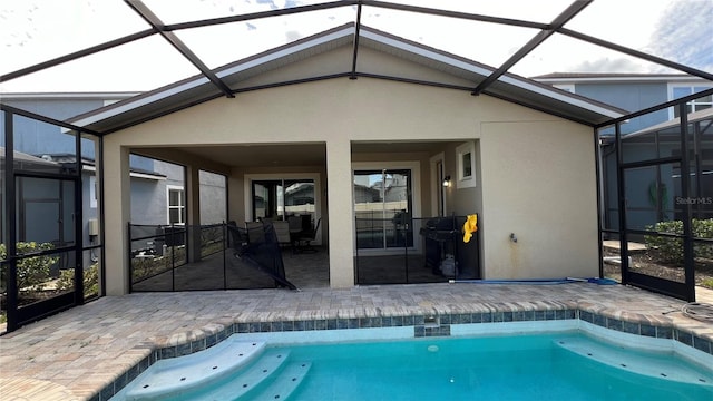 view of swimming pool featuring a patio area and glass enclosure