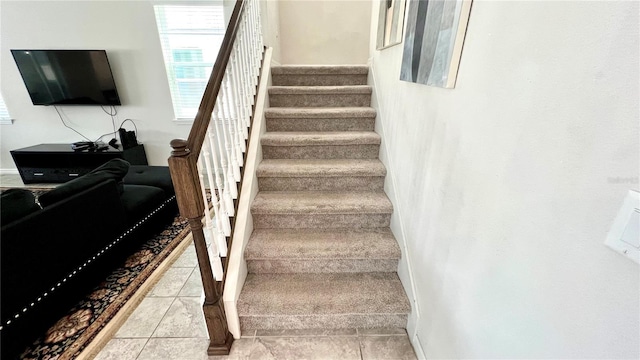 staircase with light tile floors