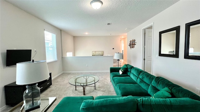 carpeted living room with a textured ceiling