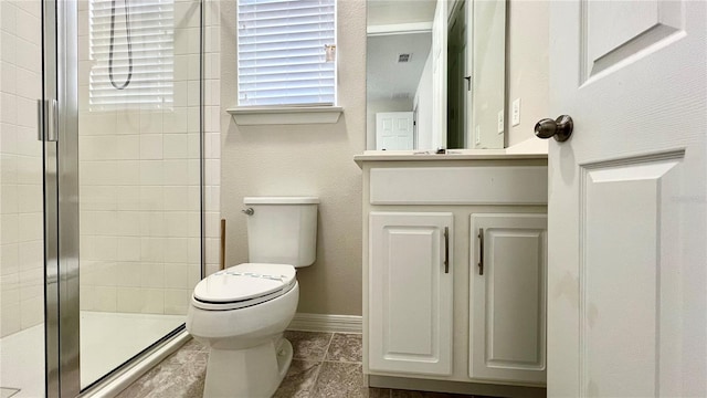 bathroom with walk in shower, oversized vanity, tile floors, and toilet