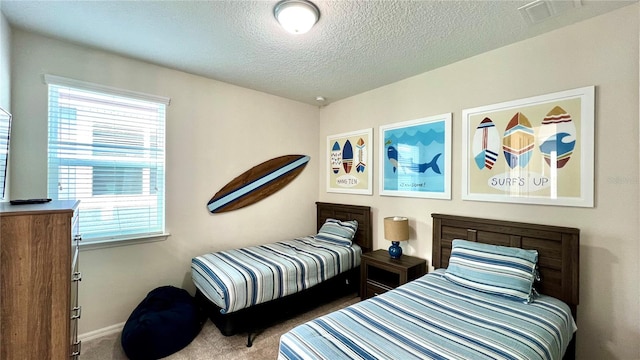 carpeted bedroom featuring a textured ceiling