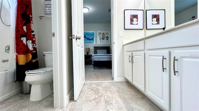 bathroom with toilet, tile floors, and shower / bath combo with shower curtain