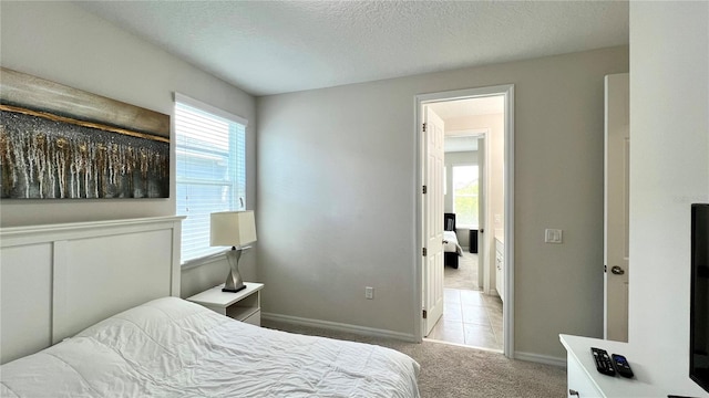 bedroom featuring a textured ceiling and light carpet