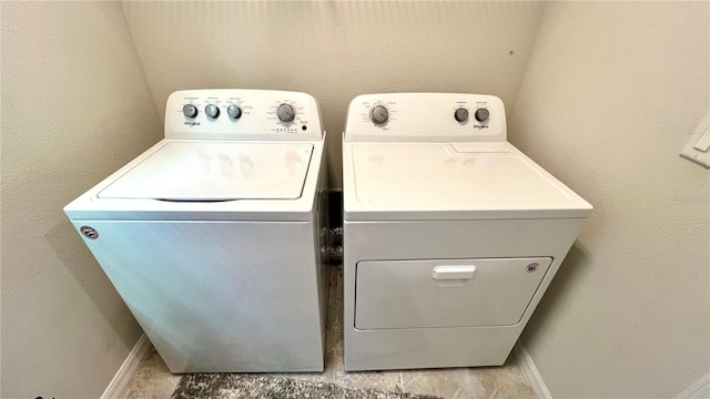 laundry room featuring independent washer and dryer and light tile floors