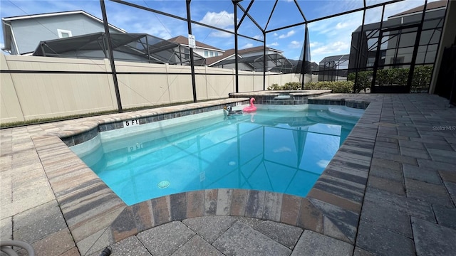 view of pool with a patio area, a lanai, and an in ground hot tub