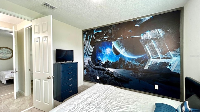 tiled bedroom with a textured ceiling