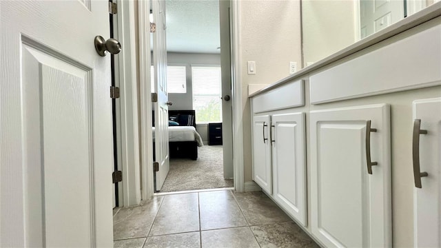 hallway with light colored carpet