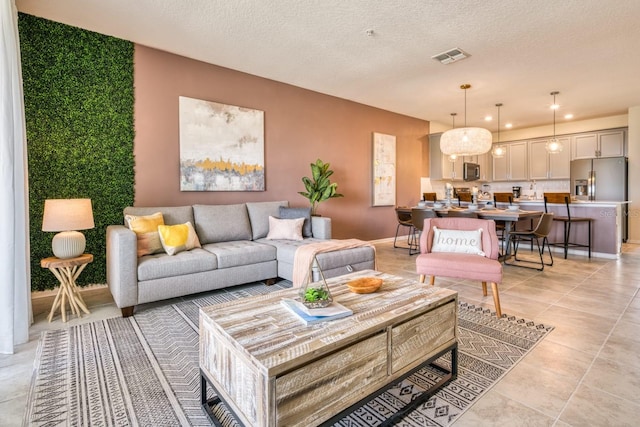 tiled living room featuring a textured ceiling