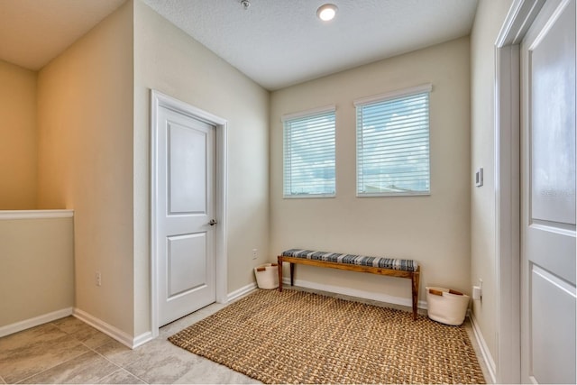 doorway to outside featuring light tile floors