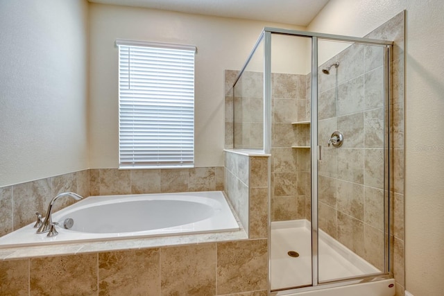 bathroom with separate shower and tub