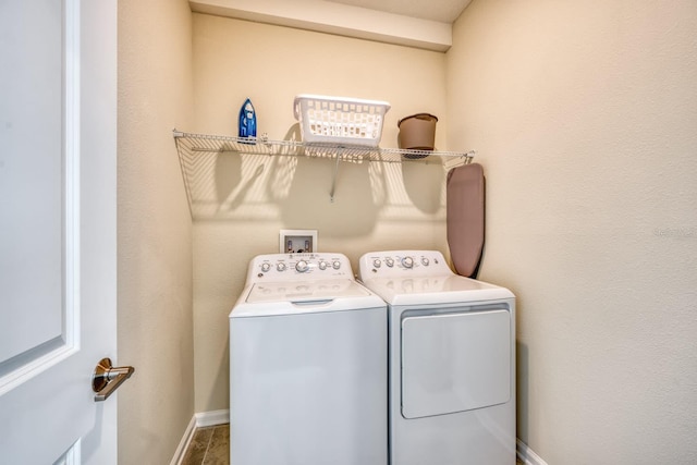 laundry area featuring dark tile floors, independent washer and dryer, and hookup for a washing machine