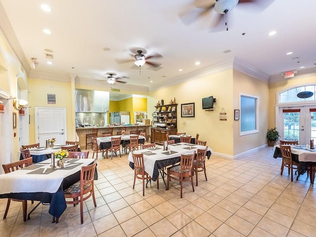 dining area featuring french doors, ornamental molding, ceiling fan, and light tile flooring