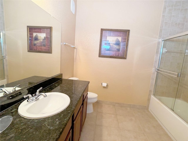 full bathroom featuring bath / shower combo with glass door, toilet, tile flooring, and large vanity