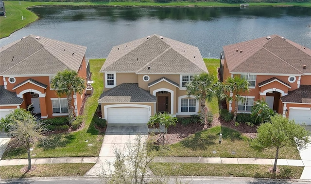 view of front of property featuring a garage and a water view