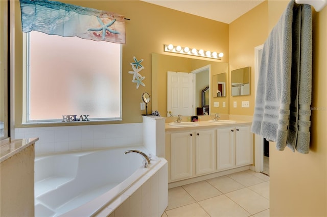 bathroom featuring a relaxing tiled tub, tile patterned floors, and vanity